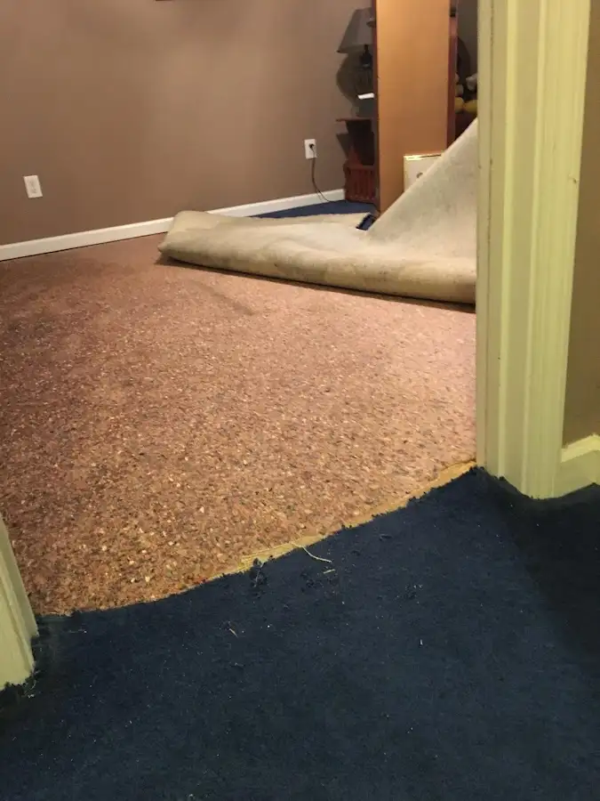 Carpet pad removal revealing water damage during Drying & Dehumidification in Mequon